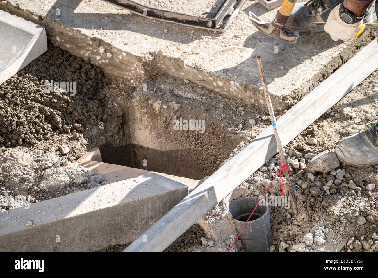 Builder using a hammer while preparing the foundation of a new building Stock Photo