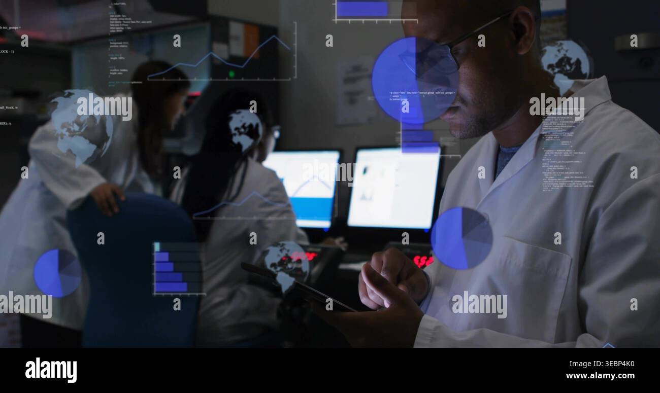 Holding tablet, male researcher monitoring charts on screens in dim lab ...