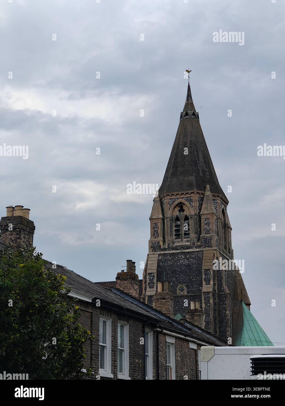 Gothic Church Spire Against Cloudy Sky in Norwich, England - Smartphone Captured Stock Image