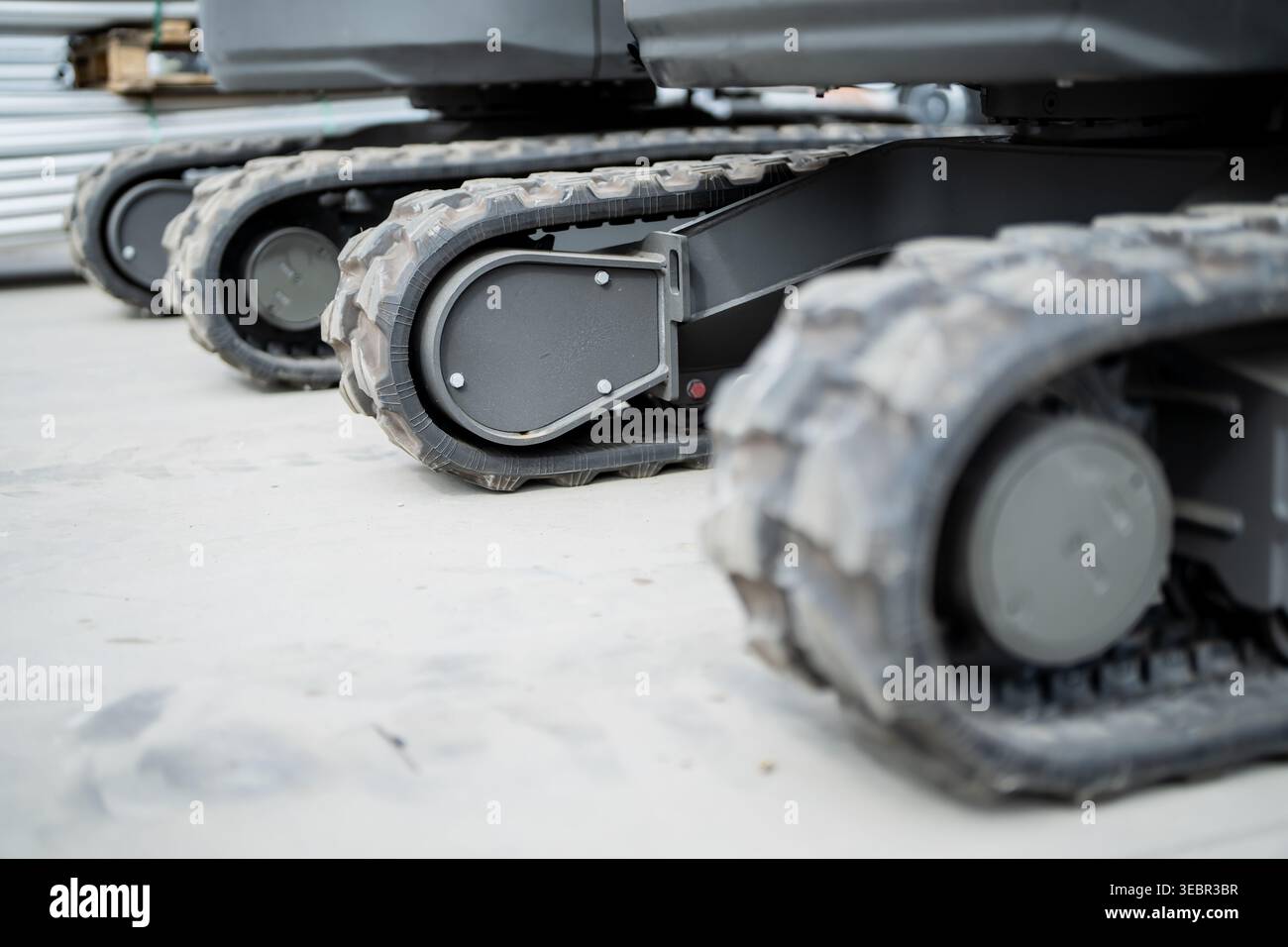 Multiple mini excavator crawler bases with rugged rubber treads and ...