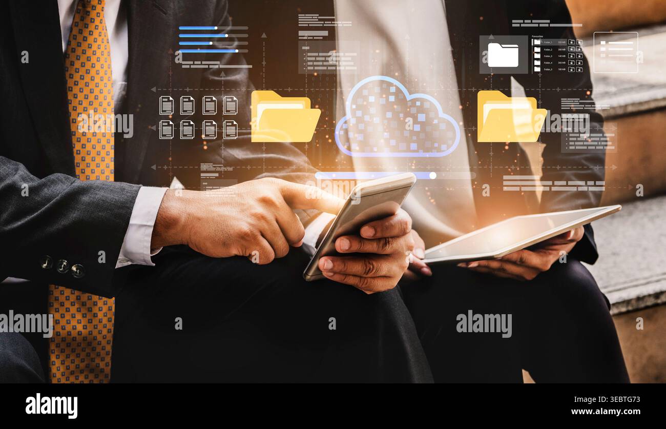 Professionals navigate digital communication using devices in a modern business setting while visual elements depict cloud technology and data Stock Photo