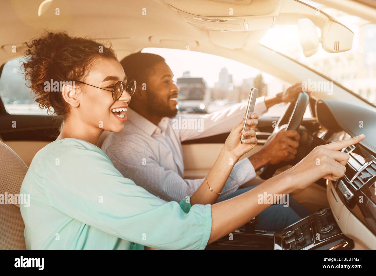 African-American Couple Using Navigator System, Driving Car Stock Photo