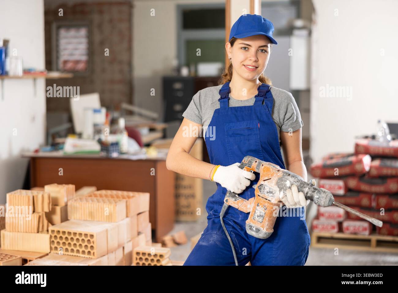 Female worker posing on indoor construction site Stock Photo