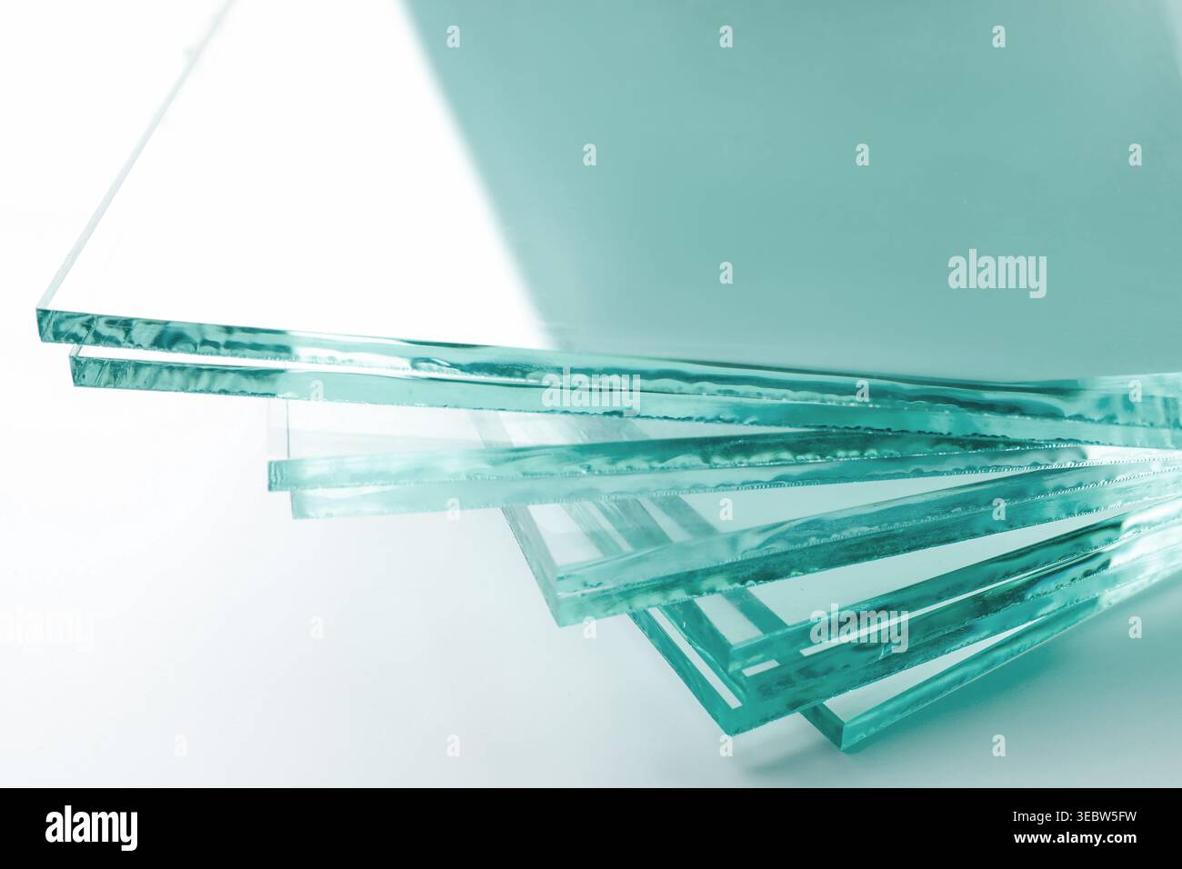 Stack of glass sheets on light background, closeup Stock Photo