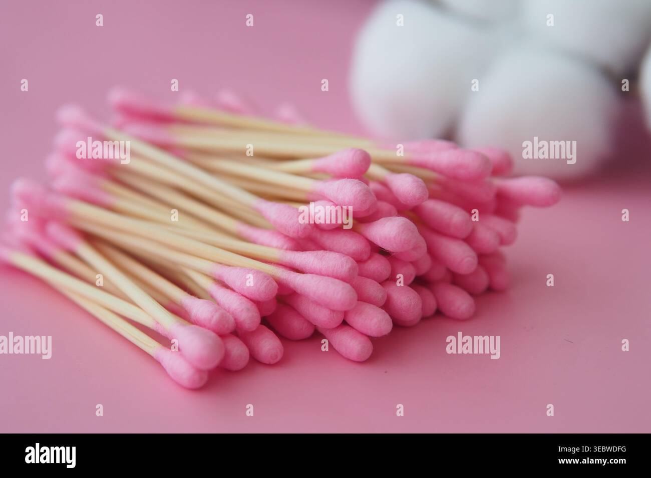 Cotton swabs arranged on pink background Stock Photo