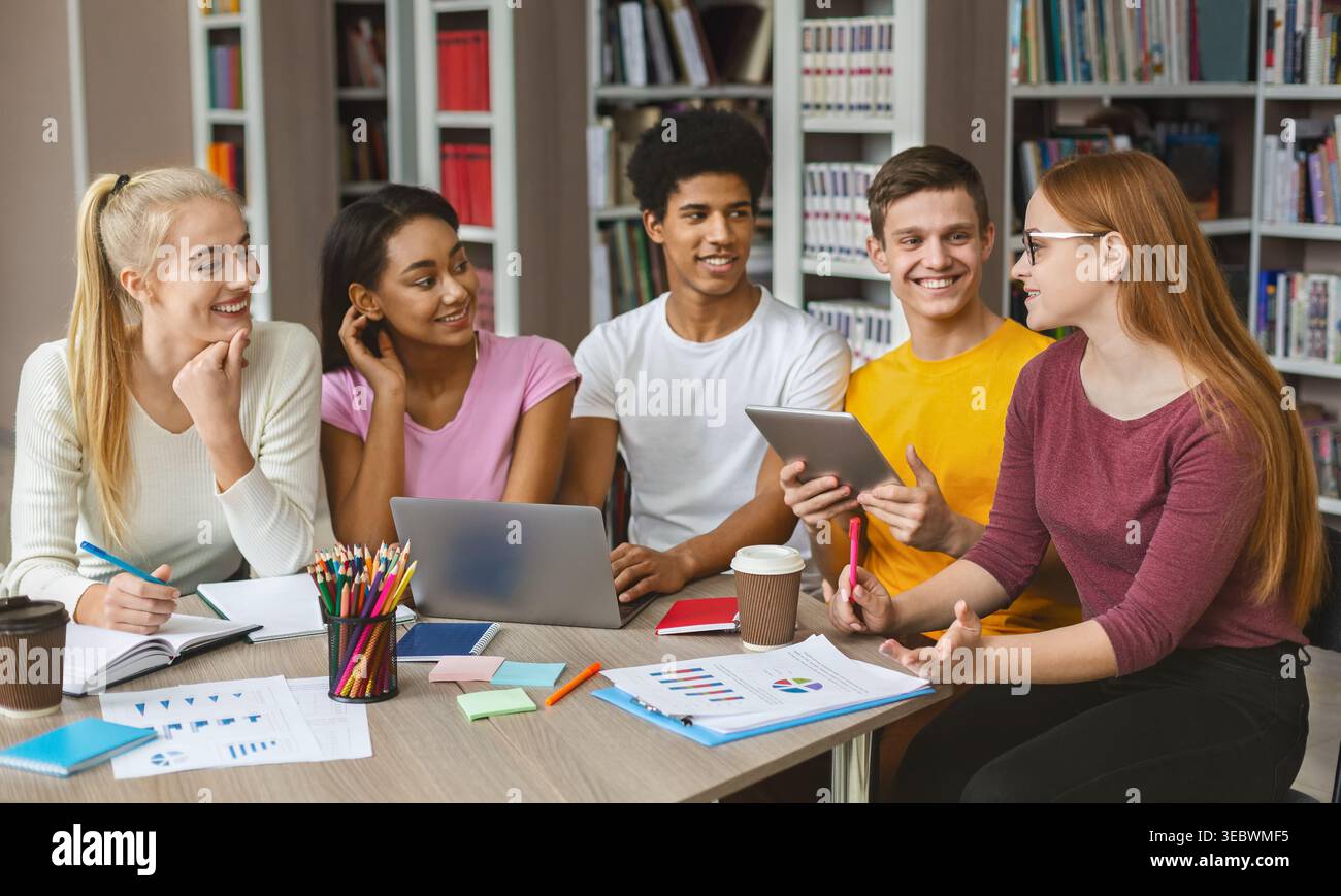 Students Engaged in Collaborative Study Session at a Library During the Afternoon Stock Photo