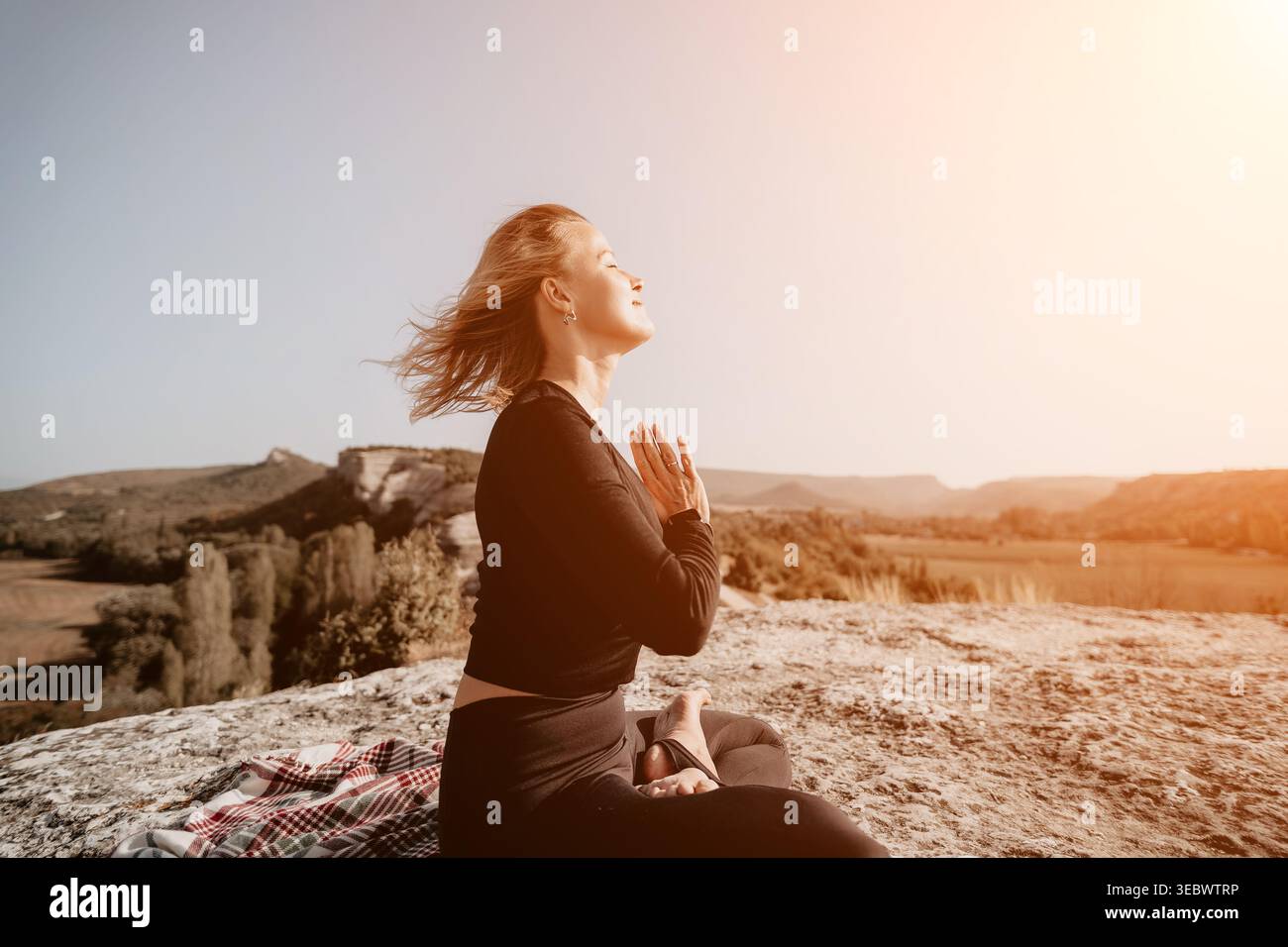 Woman Meditating on a Mountaintop Stock Photo