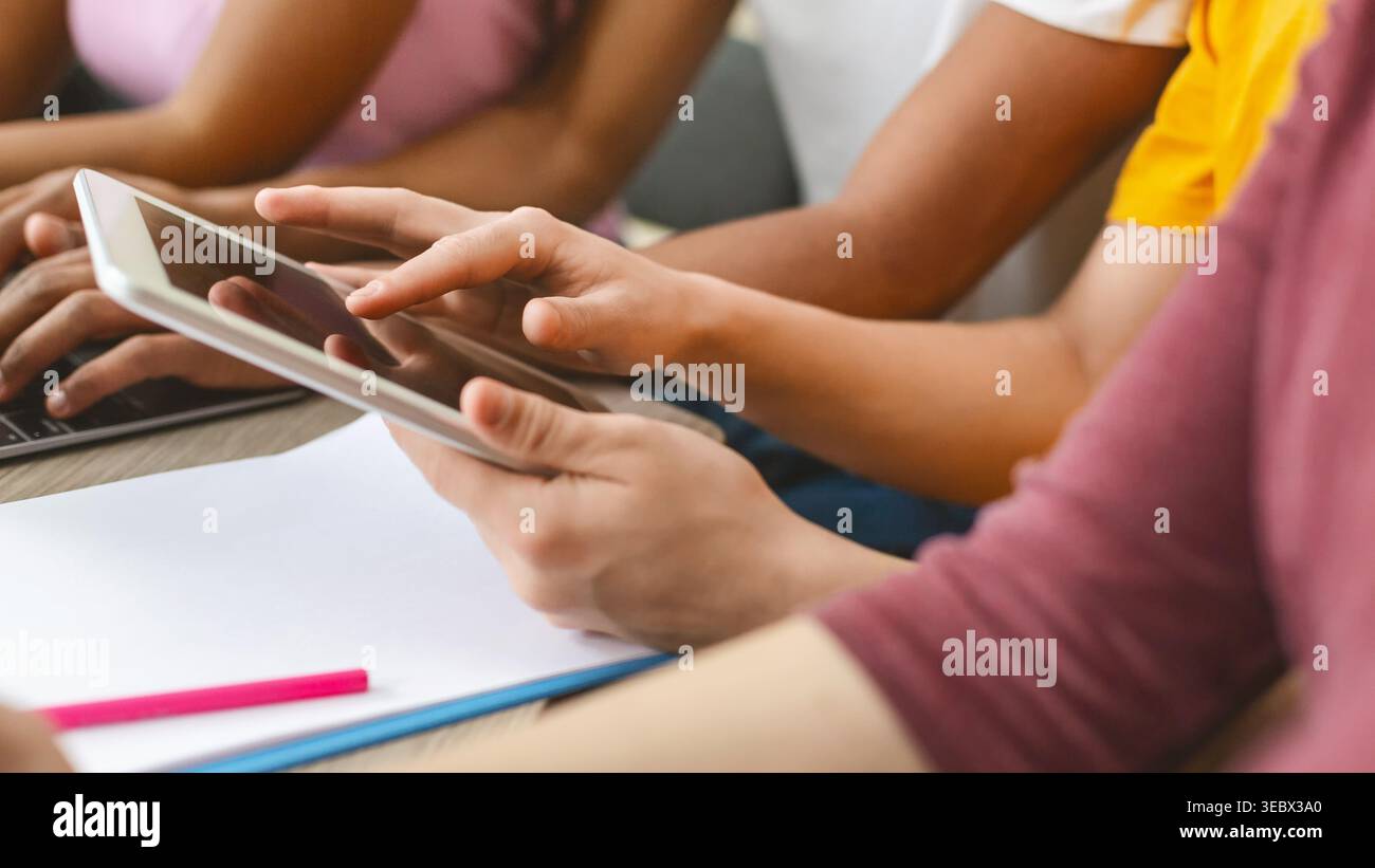 Student using tablet for studying, turning page Stock Photo