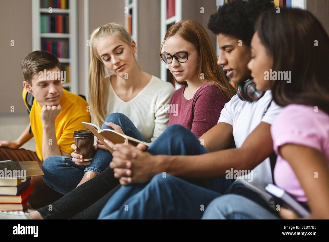 Group of Students Studying Together in a Library During the Afternoon Stock Photo