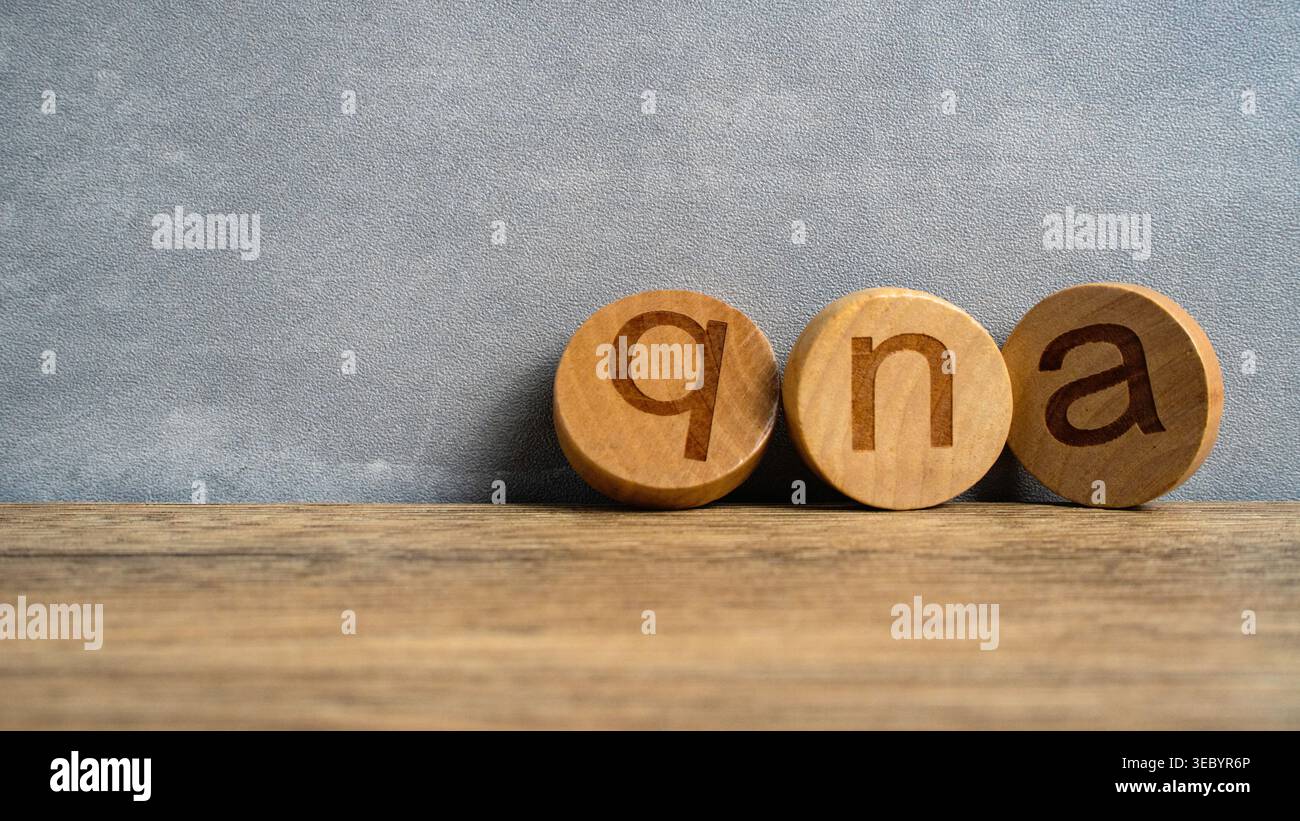 QNA Lowercase Wooden Blocks on Wood Surface Stock Photo