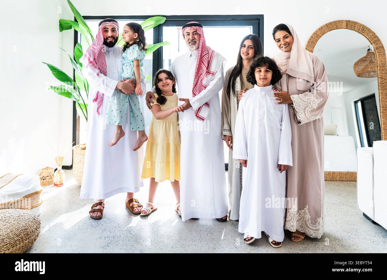 Arab parents and their children posing together for a family portrait ...