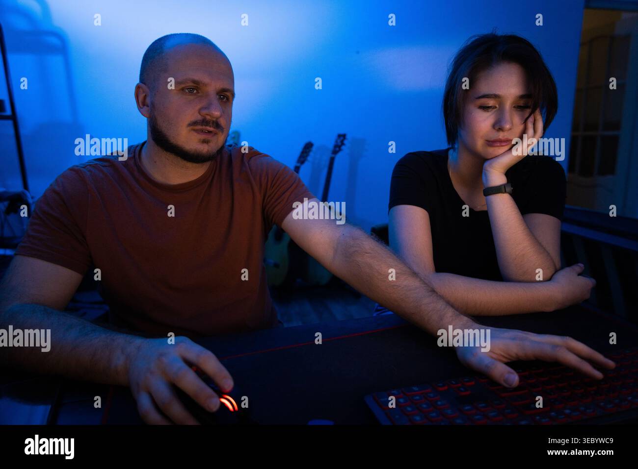 Colleagues Working Together on Project at Night Stock Photo