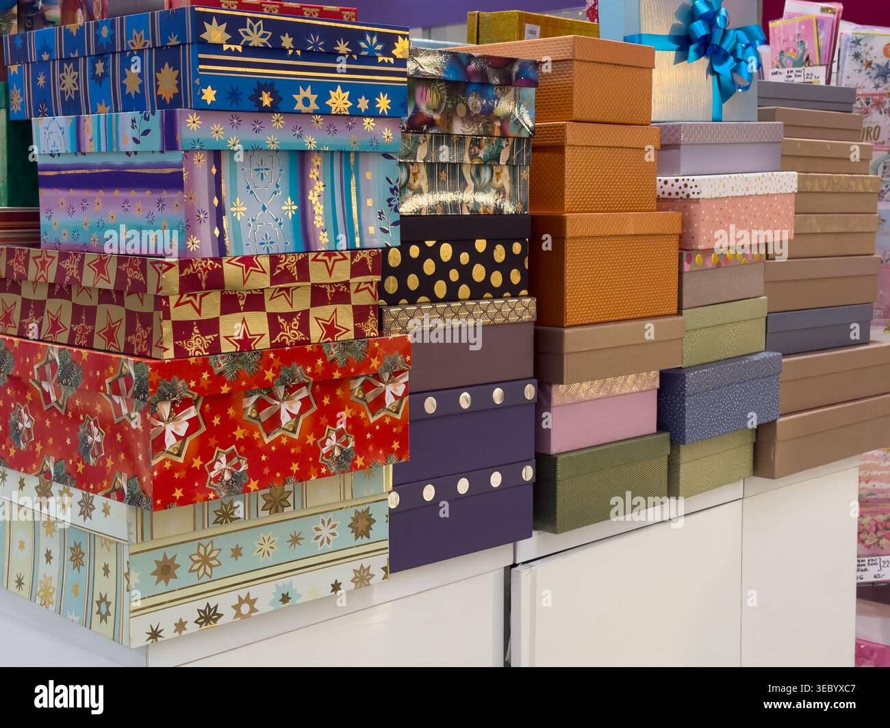 A display of assorted festive gift boxes featuring diverse patterns like stars and dots, promoting thoughtful gifting and holiday cheer Stock Photo