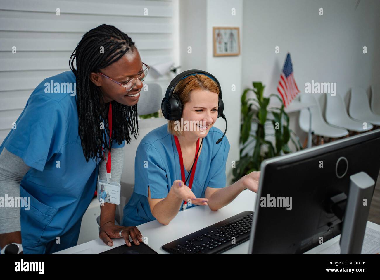 Healthcare professionals collaborating on computer using telemedicine technology Stock Photo