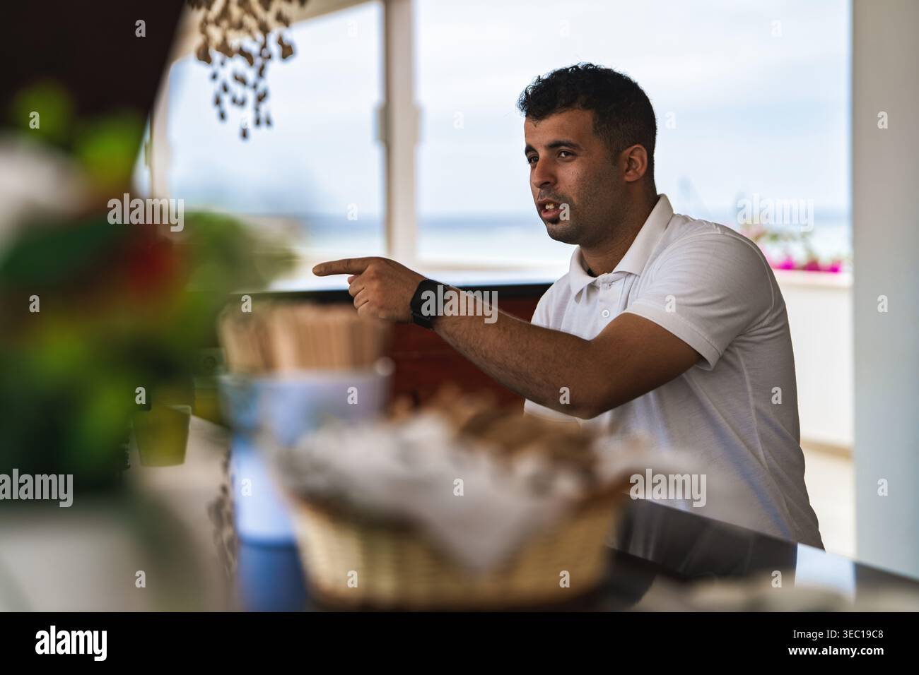 Marsa alam, egypt 21 april 2026: young man wearing a white polo shirt ...
