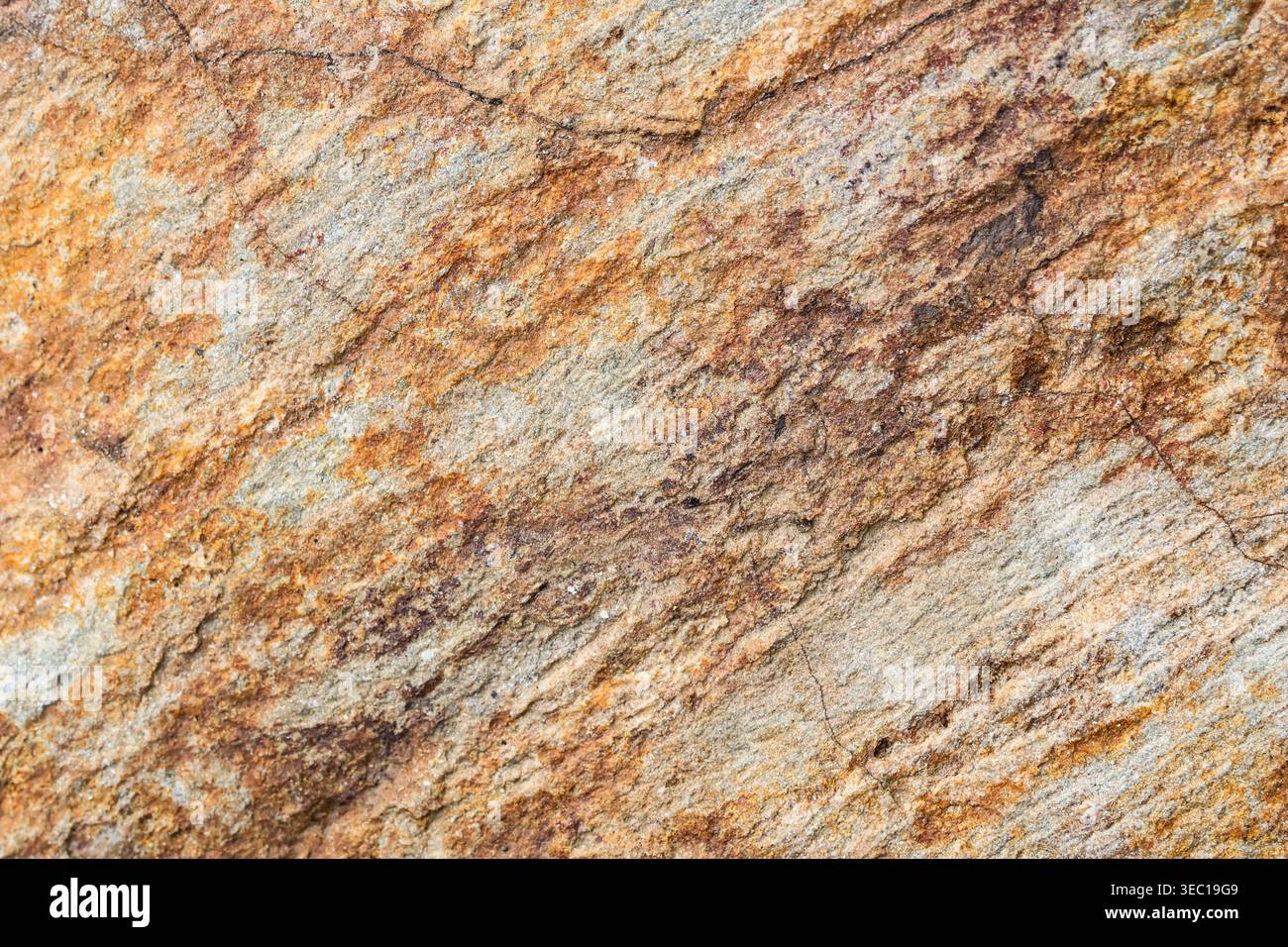 Beautiful warm natural stone texture background showing rough rock pattern surface with rich brown and orange mineral layer providing peaceful calming Stock Photo