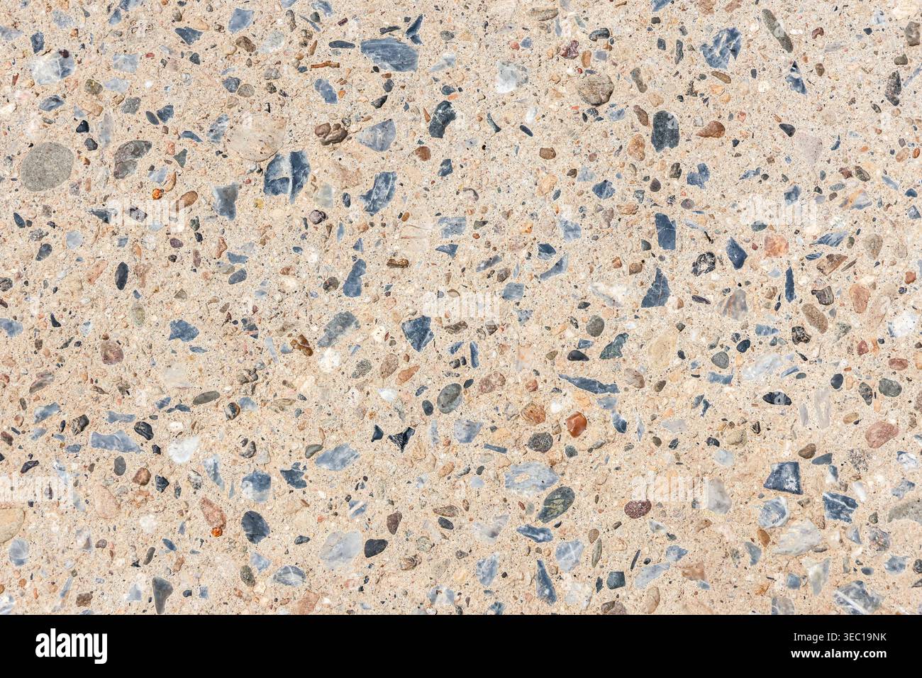 Close up texture of exposed aggregate concrete surface showing small stone and pebble pattern creating natural gravel background giving very calm and Stock Photo