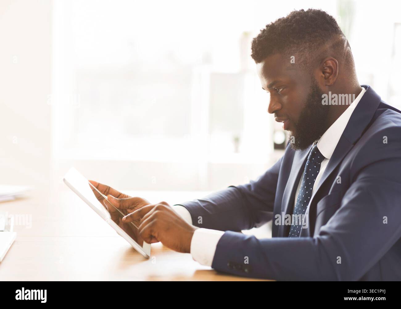 Young entrepreneur using business application on digital tablet Stock Photo