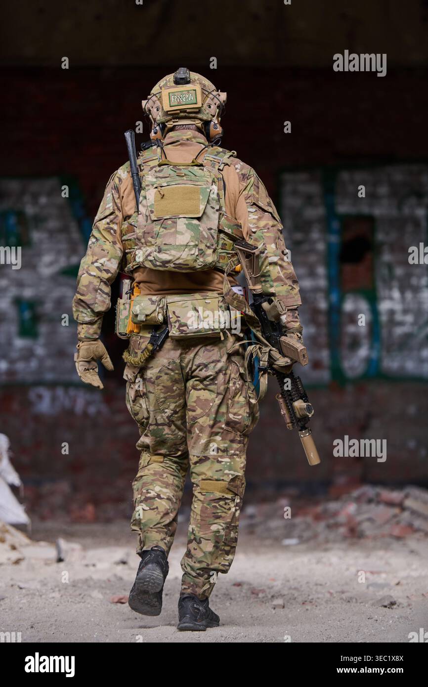 Armed Soldier In Camouflage Tactical Gear Walking Through Urban Ruin On ...