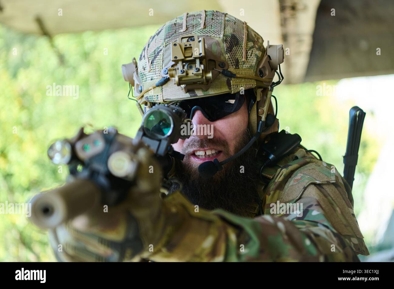 Tactical Soldier in Camouflage Aiming Rifle With Helmet Optics and ...