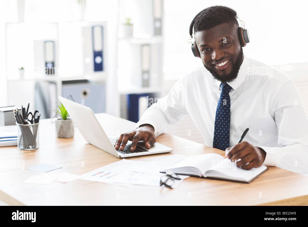 Happy black businessman learning foreign language online Stock Photo