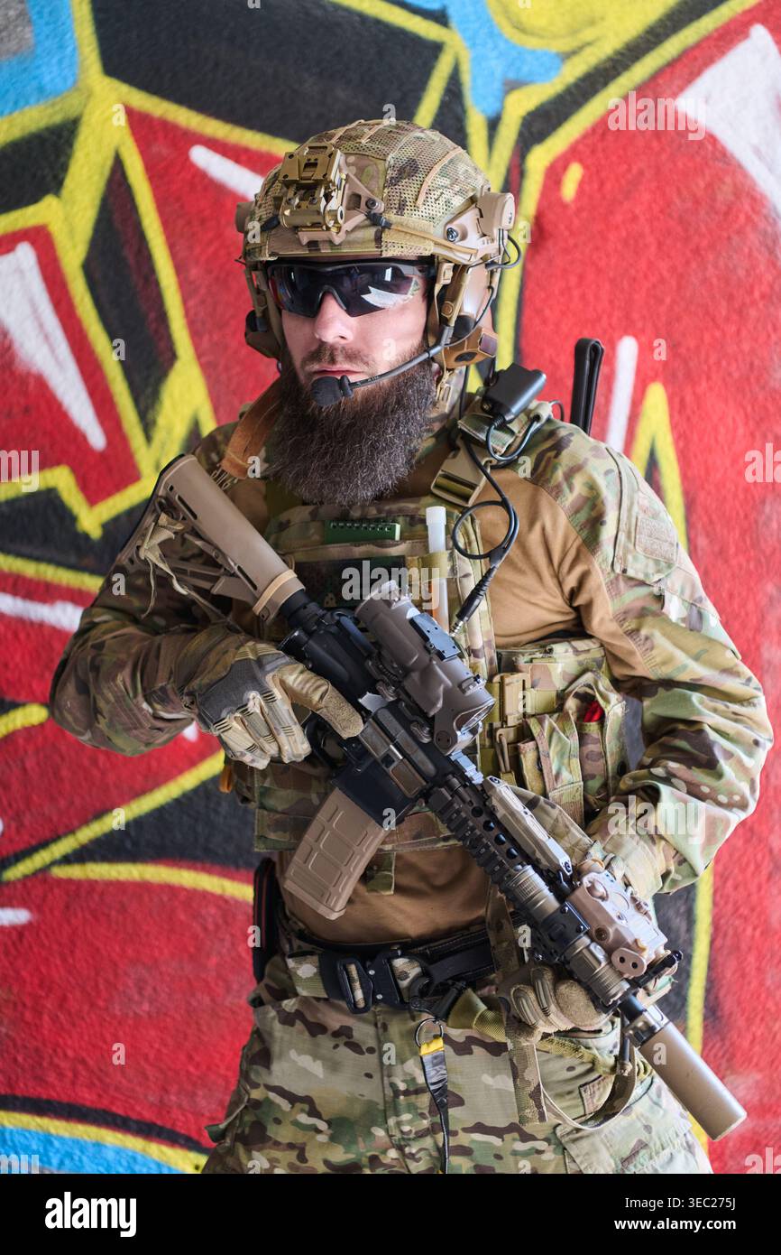 Bearded Soldier In Tactical Gear With Rifle And Camouflage Standing ...