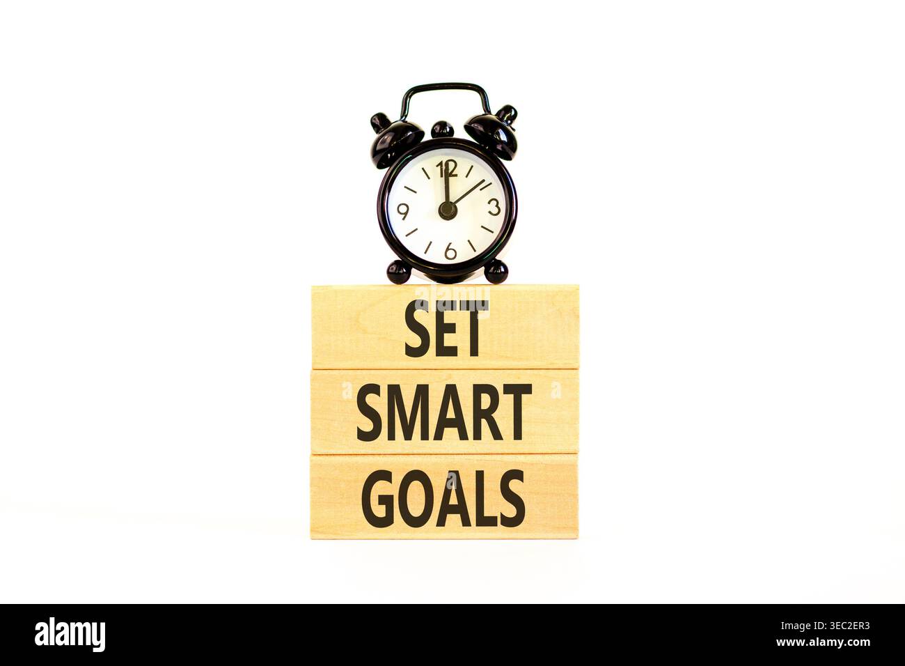 Set smart goals words symbol. Concept words Set smart goals on beautiful wooden blocks. Beautiful white background. Black alarm clock. Business and se Stock Photo