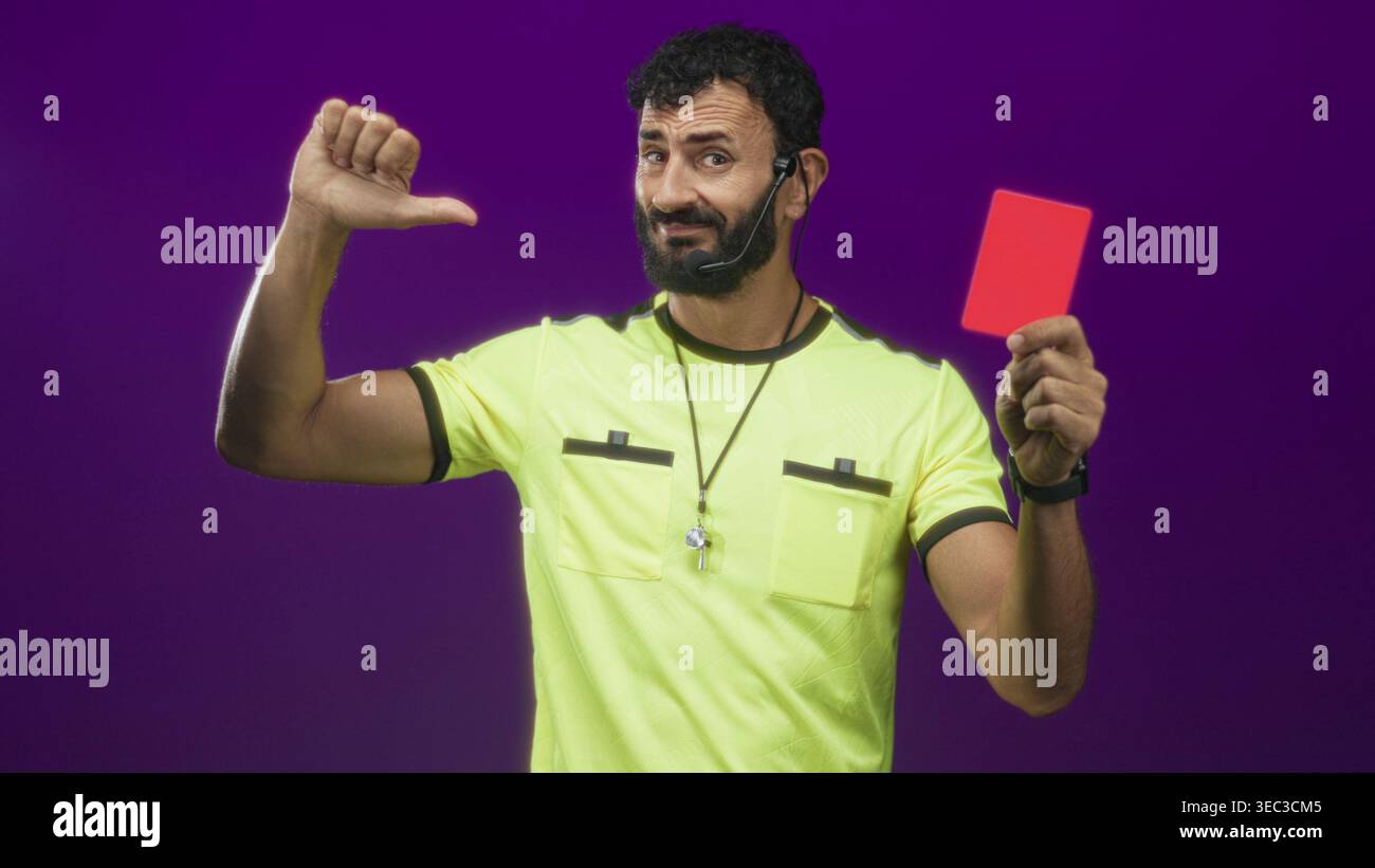Man referee wearing neon yellow uniform and whistle on lanyard holding ...