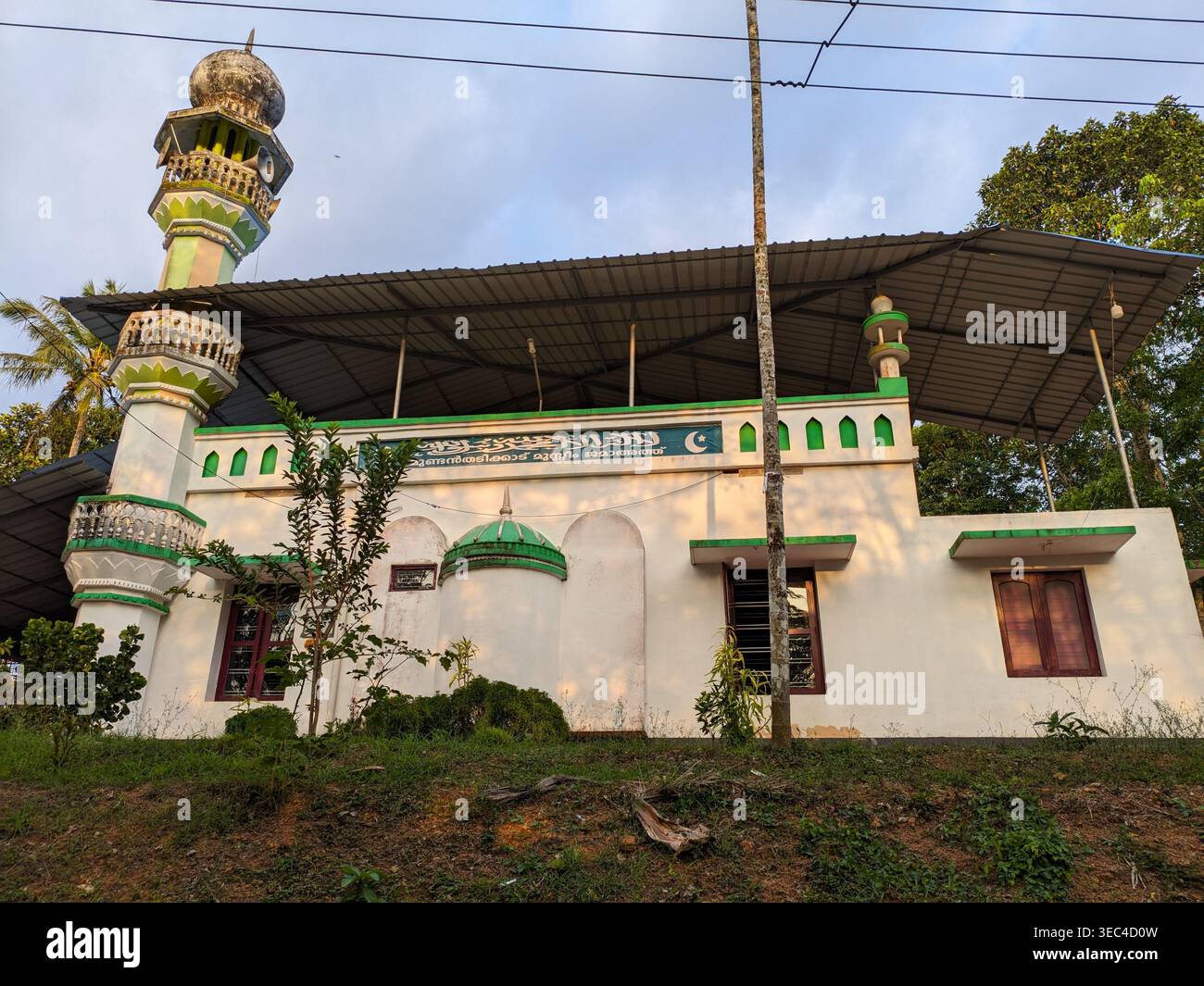 Small Rural Mousque Mosque in rural Kerala, India surrounded by lush greenery and tropical ...