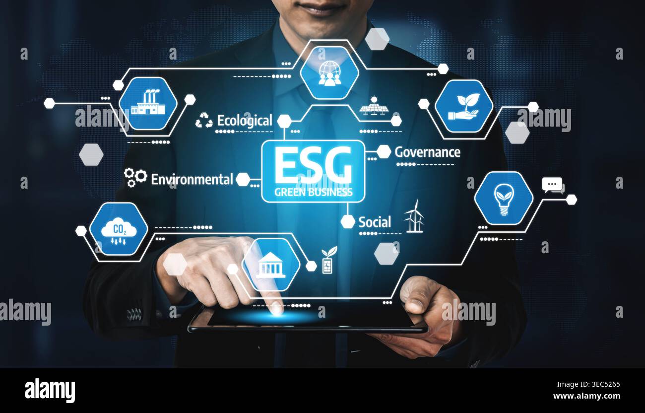 A businessman interacts with a digital tablet showcasing ESG concepts, including environmental, social, and governance factors crucial for sustainable Stock Photo