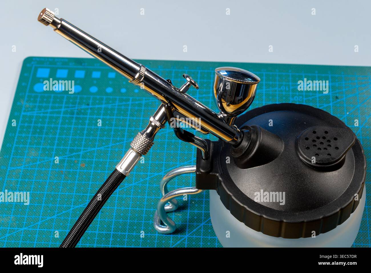 Close-Up of Airbrush Tool on Cutting Mat – Precision Craft and Design Workspace Stock Photo
