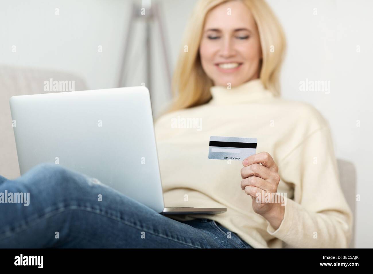 Middle-Aged Woman Using Credit Card For Paying Stock Photo