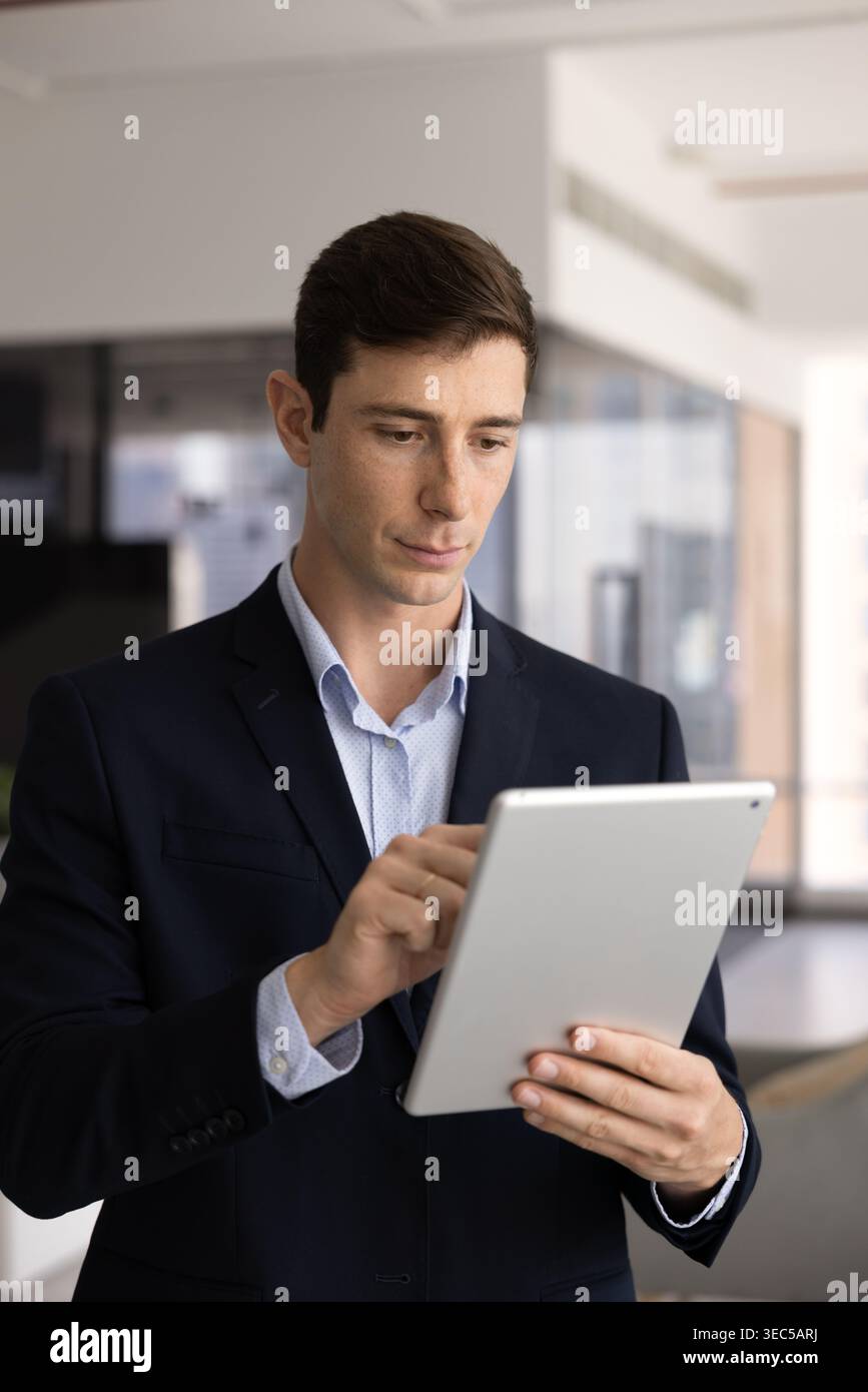 Young male executive working on modern tablet device Stock Photo
