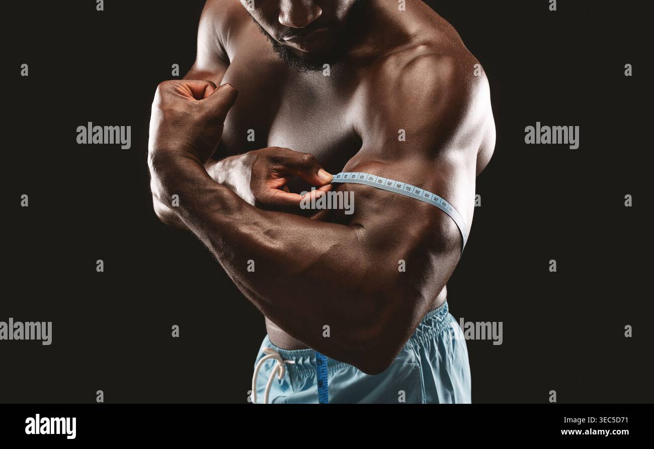 Measuring Bicep Size With Tape While Flexing Muscles in a Bodybuilding ...