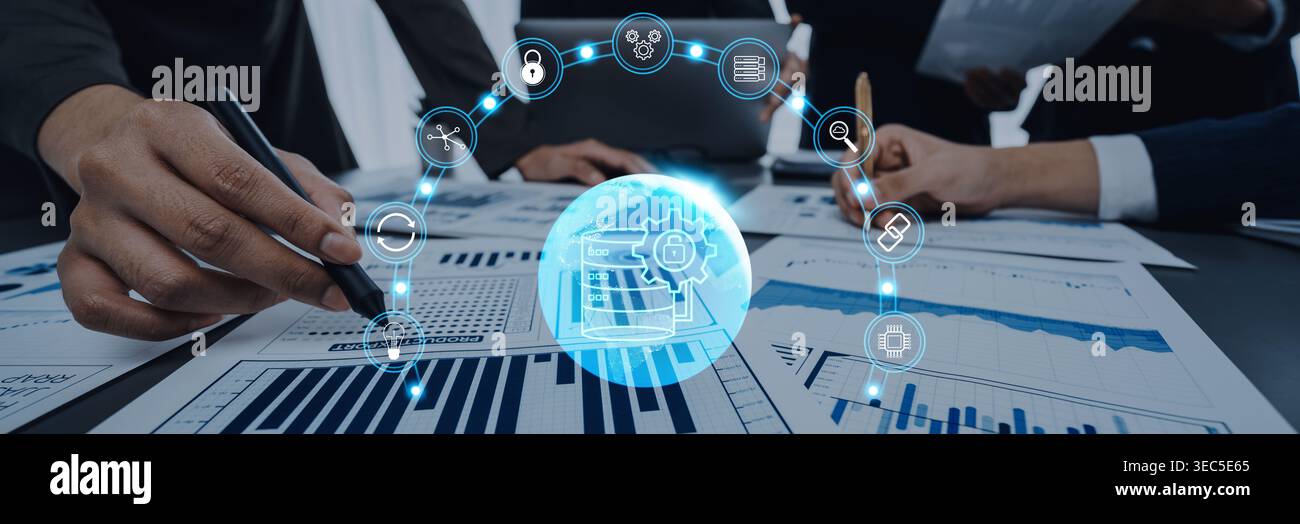 A dynamic business team works together to analyze charts and graphs, highlighting technology and analytics in a collaborative office setting. Perfect Stock Photo