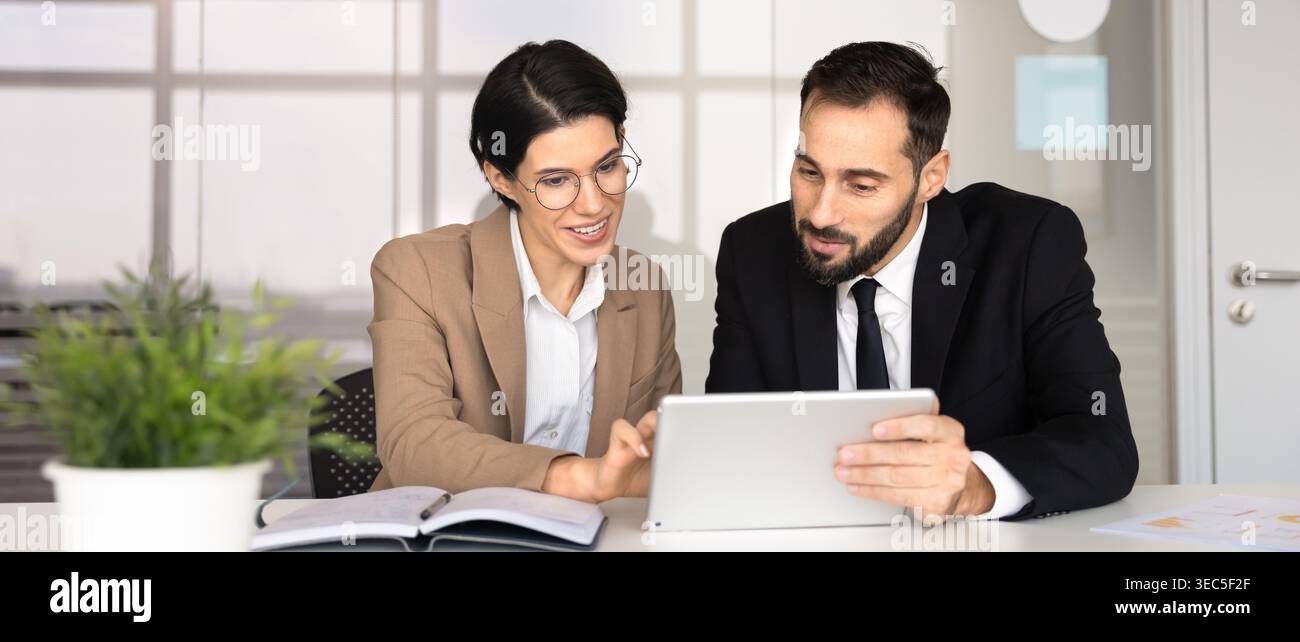Colleagues collaborating on strategy using digital tablet in office Stock Photo