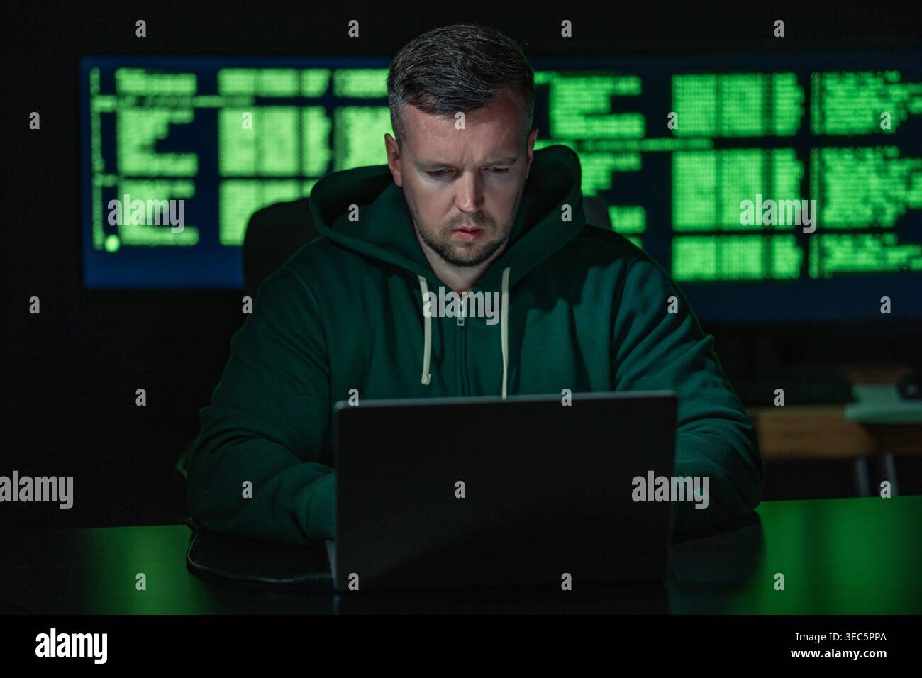 Hacker works on programming and coding. Hacker analyzes digital system vulnerabilities. Hacker monitors secure network infrastructure. Hacker attempts Stock Photo
