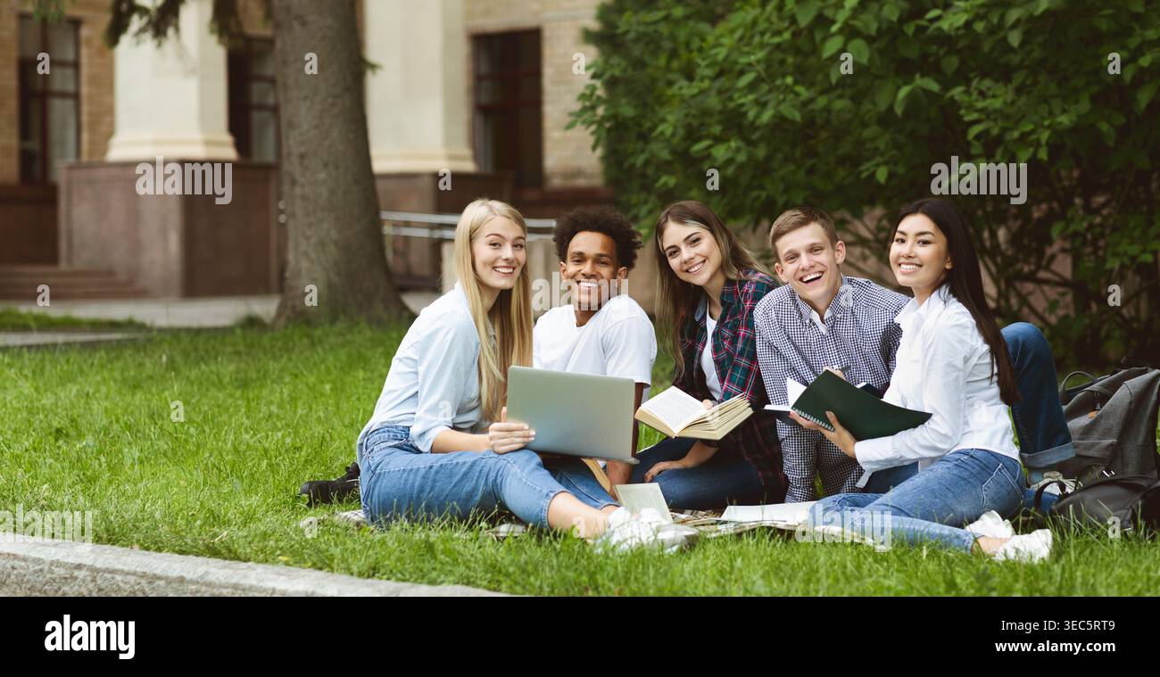 University students resting in campus, smiling to camera Stock Photo