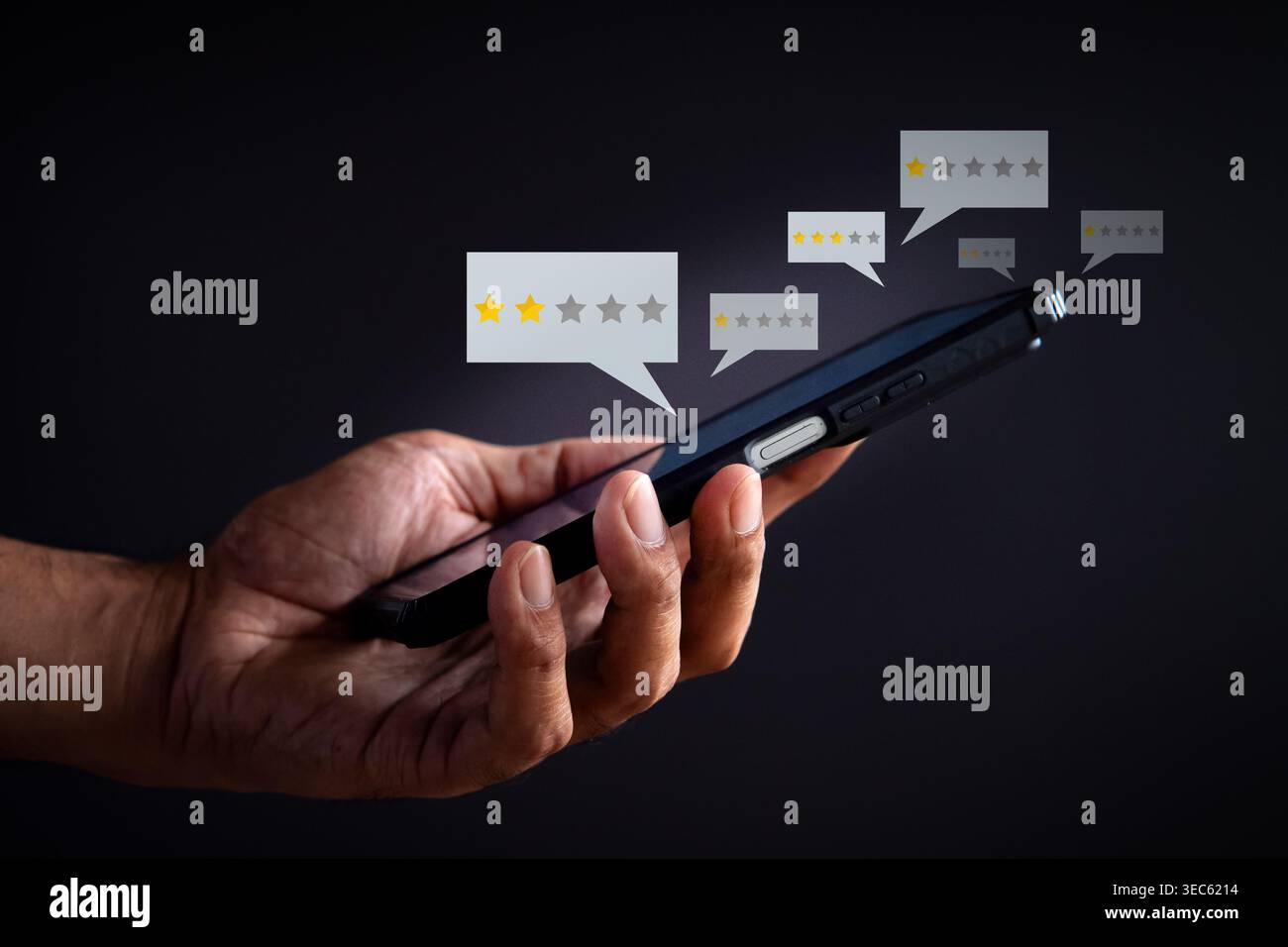 A hand holds a smartphone displaying low star rating bubbles on a dark background. Negative customer feedback, poor reviews concept. Stock Photo