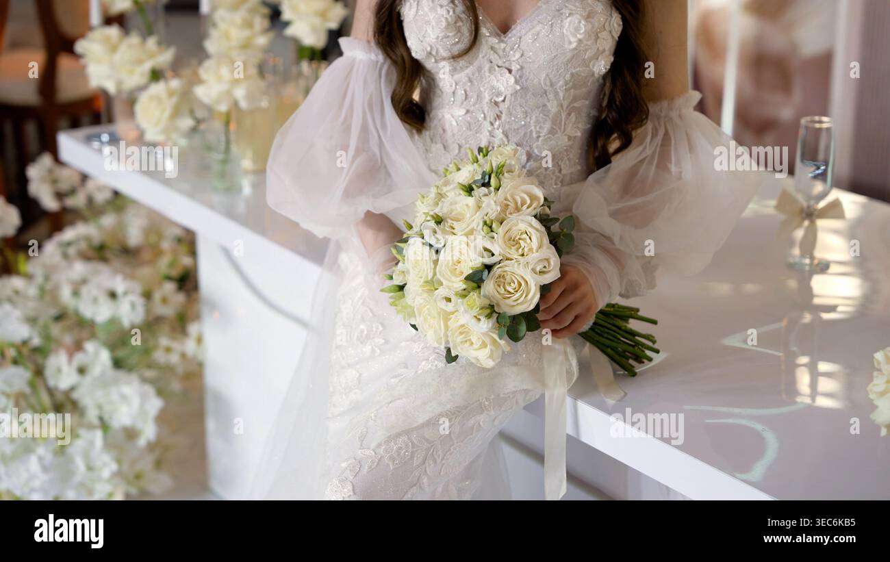 white bouquet with ivory dress A Cascading White Bouquet with Brooches