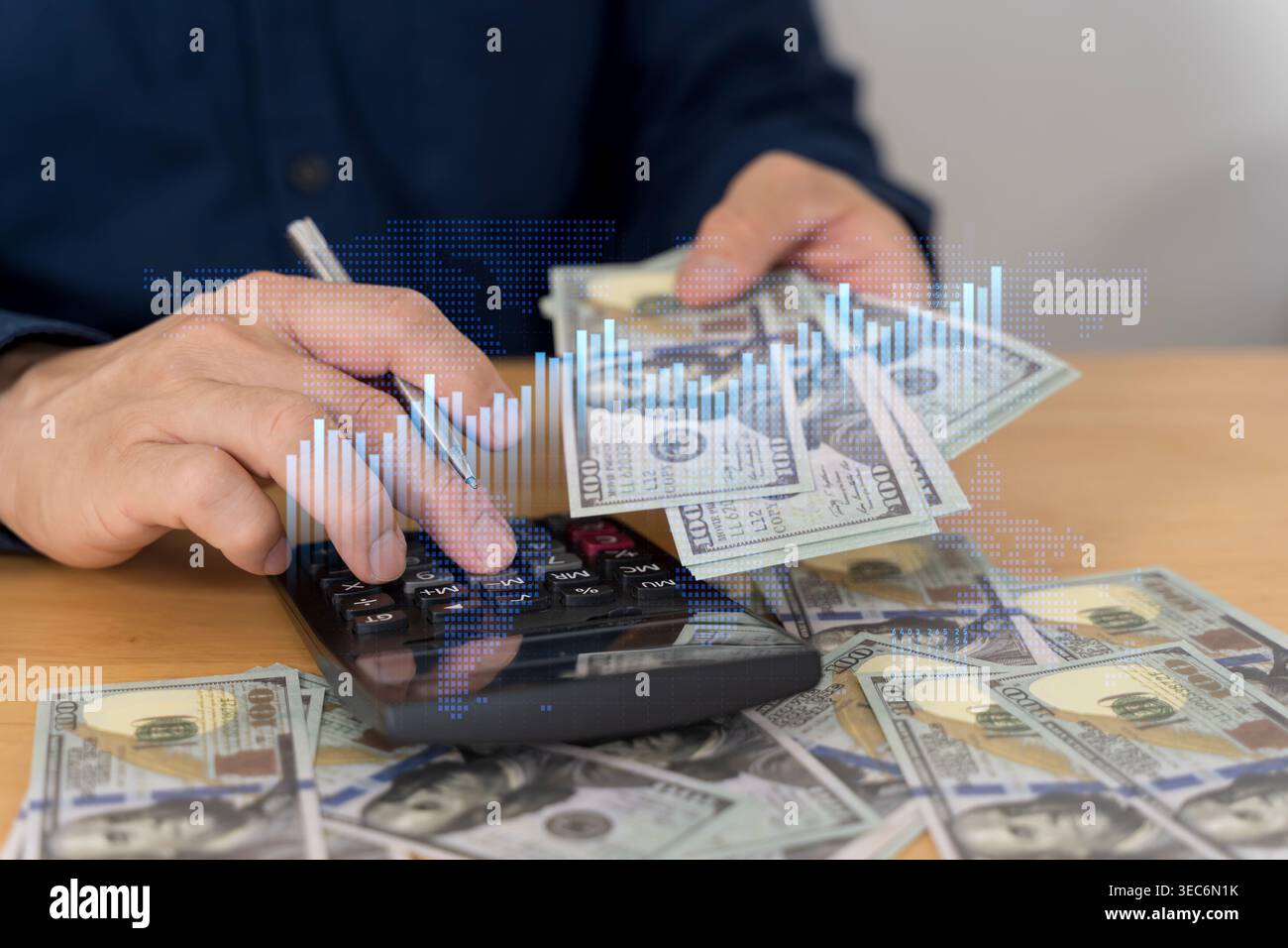 Close-up of hands counting US dollar bills beside a calculator and pen ...