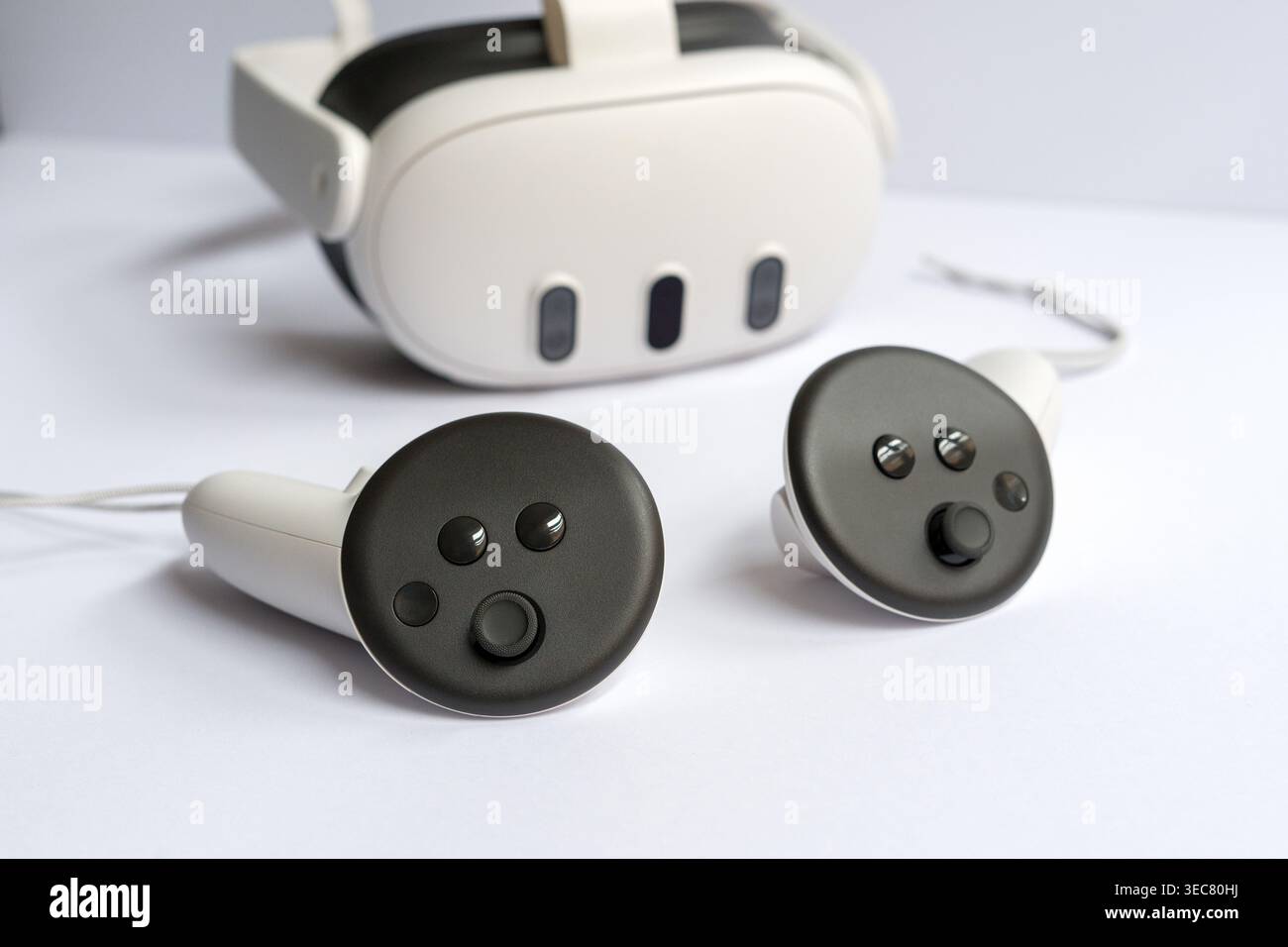 Modern virtual reality headset with controllers placed on white background, technology concept for gaming, simulation and immersive experience. Stock Photo