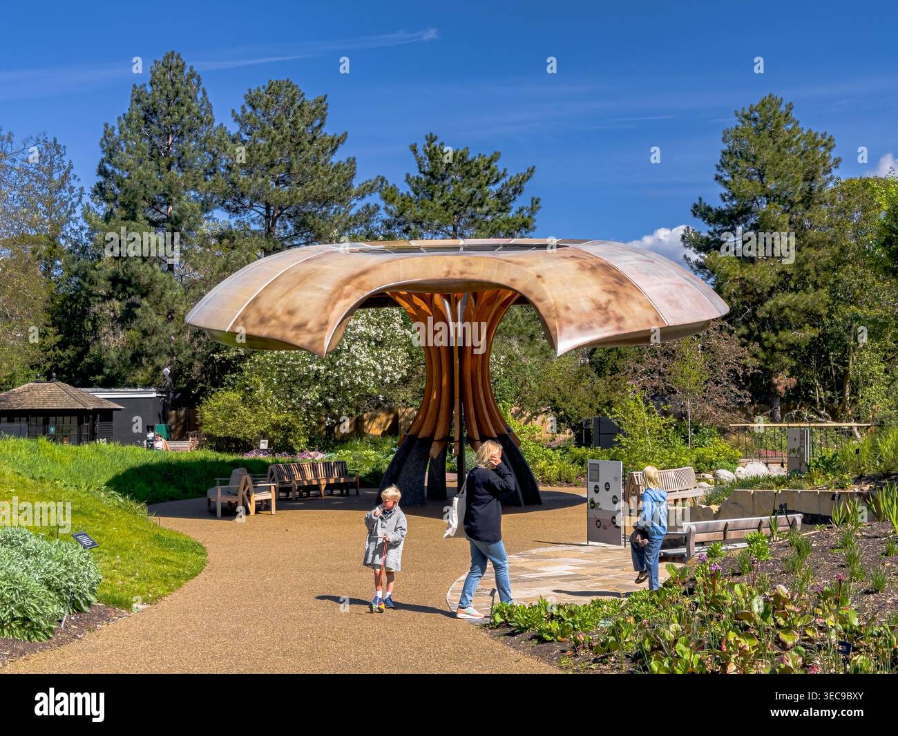 People at The Carbon Garden near the large, wooden mushroom-like pavilion , to highlight the role of carbon in supporting life on Earth at Kew Gardens Stock Photo