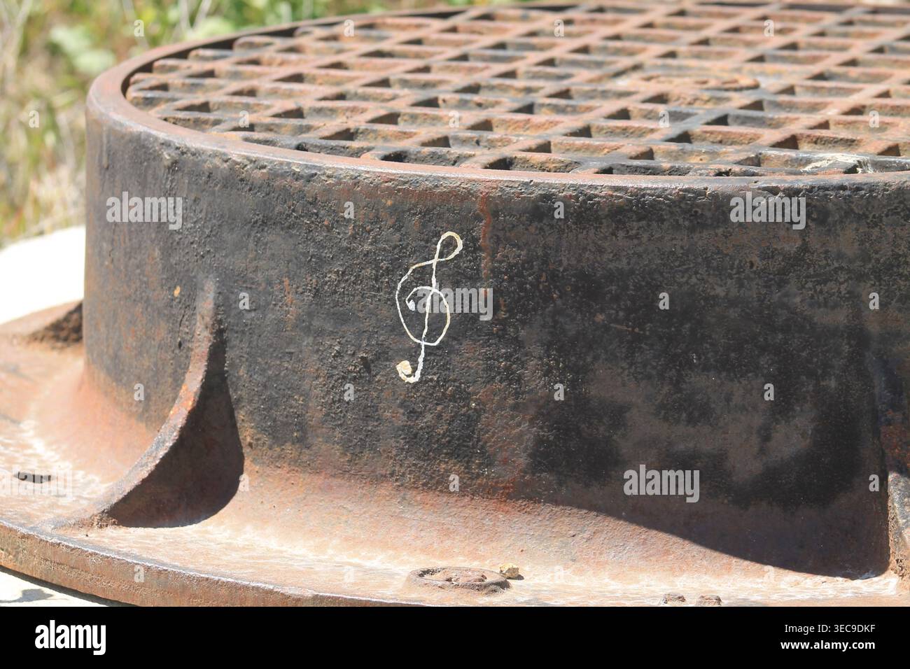Treble Clef Drawn On Rusty Manhole Cover Stock Photo