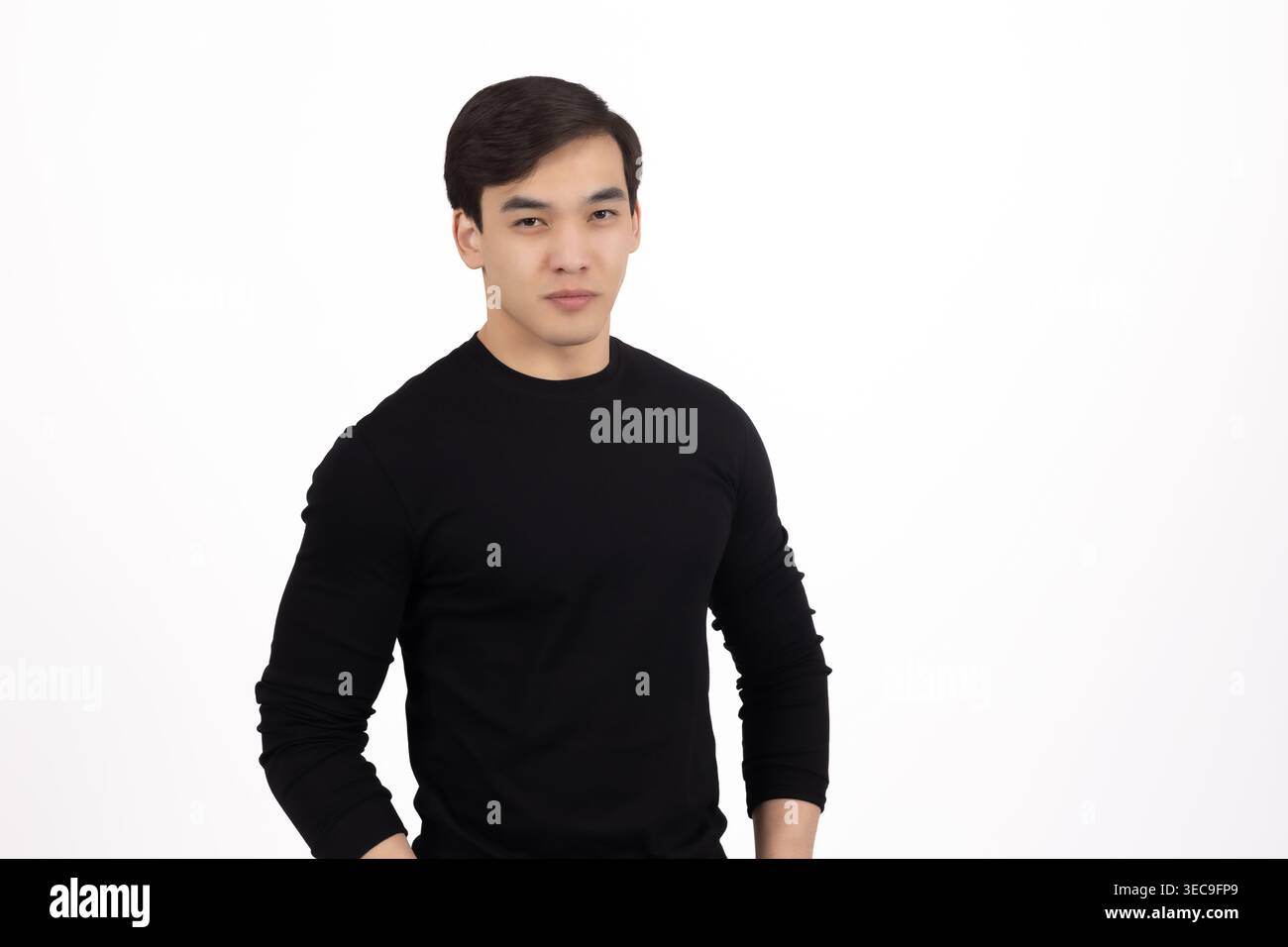 Young man in black sweater looking thoughtfully at camera Stock Photo