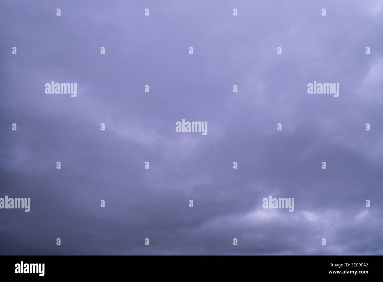 Purple and grey moody sky with thick cloud cover Stock Photo