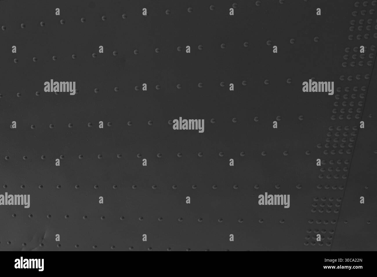 Texture suggests industrial use or mechanical construction. Each rivet aligned in straight rows creates structured grid Stock Photo