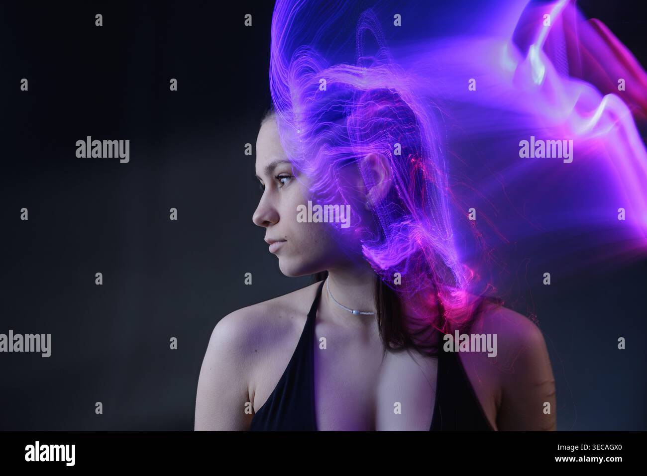 Portrait with purple light effects illustrating artificial intelligence, neural activity, and mental processing. Stock Photo