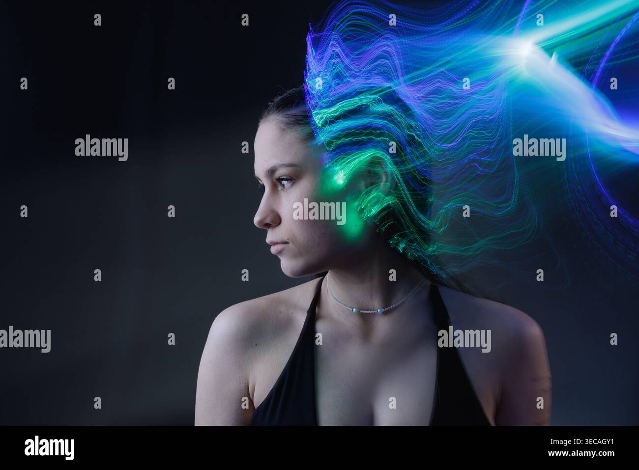 Portrait with multicolor light trails representing artificial intelligence, neural signals, and data processing. Stock Photo