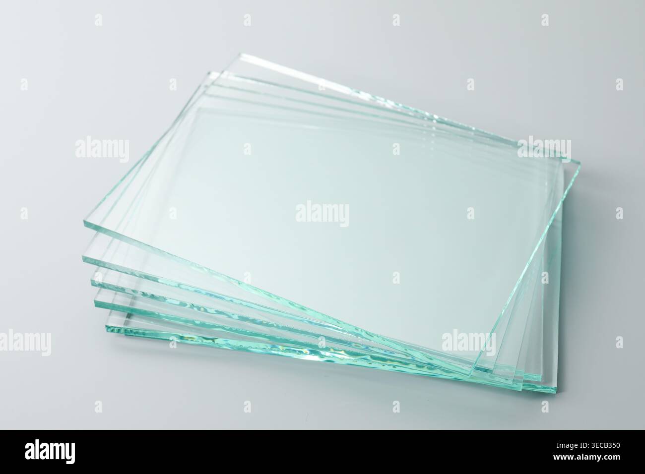 Stack of glass sheets on light grey background, closeup Stock Photo